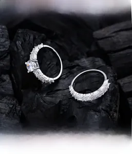 Macro detail of 925 silver wedding rings set featuring micro-pave setting on black texture