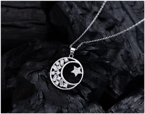 Macro shot of S925 sterling silver stamp on crescent moon and star pendant with zircons