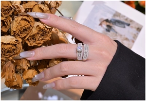Detailed view of luxury silver stacking ring set with marquise cut stones on a model hand