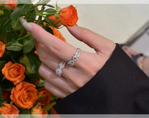 Close-up of S925 silver butterfly ring set with pavé cubic zirconia on finger