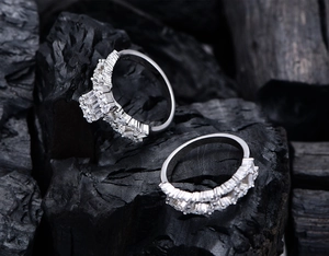 Macro shot of rectangular zircon silver ring set with micro-pave band on charcoal background
