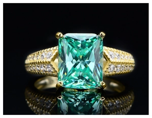 Macro shot of 5.6ct emerald cut yellow carbon diamond ring with side stones in 14k gold