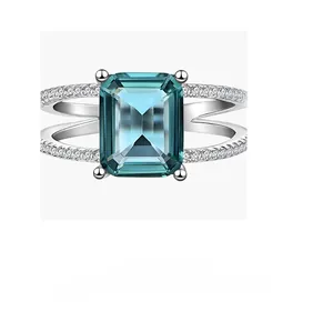Macro view of emerald-cut blue gemstone ring with split-shank silver band detailing