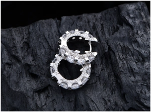 Macro shot of S925 sterling silver hoop earrings with brilliant row of pavé set zircons