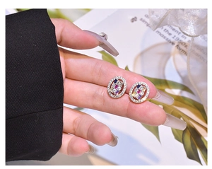 Macro shot of S925 sterling silver oval stud earrings with colorful gemstones and crystals