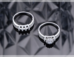 Macro shot of S925 silver double ring set featuring a floral cluster and micro pave diamonds