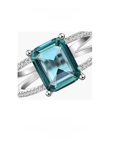 Macro shot of emerald-cut dark green stone ring with micro-pave setting on silver band