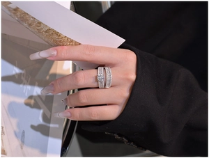 Close-up of S925 silver double ring set with round main diamond and marquise pave stones