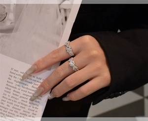Close-up of S925 silver rings with snowflake design and zircon inlay on a model hand