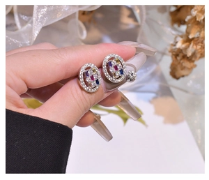 Detailed view of oval multicolored gemstone earrings in S925 sterling silver with micro-pave