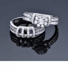 Macro detail of S925 silver flower rings set with sparkling zircon on reflective black surface