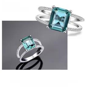 Detailed macro of S925 sterling silver ring with emerald-cut teal gemstone and pave band