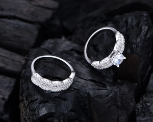 Detail shot of wavy zircon silver ring set with round solitaire and pave diamonds