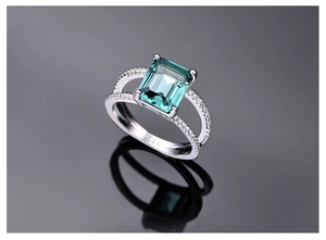 Macro shot of emerald-cut dark green gemstone ring set in S925 sterling silver band
