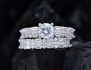 Macro shot of 925 silver wedding ring set with main round stone and accent diamonds