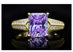 Macro view of luxurious gold ring with purple stone and micro-pave diamond setting