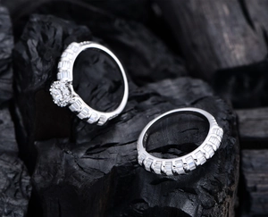 Macro shot of S925 sterling silver ring set with micro-pave zirconia on a dark rock background