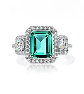 Macro shot of 925 silver ring featuring emerald cut green stone with side stones