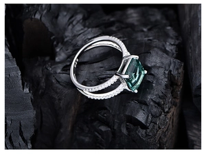 Macro view of emerald-cut dark green gemstone ring with S925 hallmark on silver band