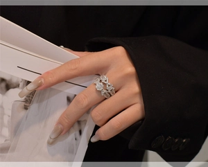 Luxury S925 silver arrow and snowflake stacking rings set worn on middle finger
