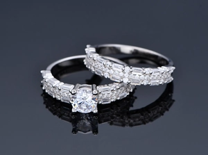 Macro shot of wedding set featuring 6mm round cut stone and multi-row pave diamonds