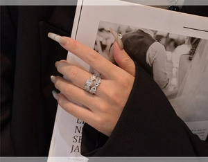 Detail shot of micro-pave silver ring with sparkling cubic zirconia on model hand