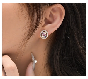 Close-up of a round halo stud earring featuring multicolor pave gemstones on a female model