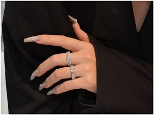 Detail shot of luxury S925 silver marquise set worn on hand over black background