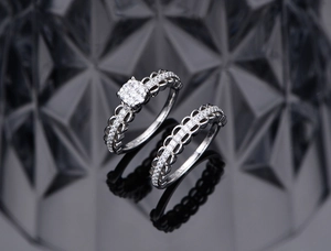 Macro detail of S925 silver lace mesh design rings with brilliant sparkling diamonds