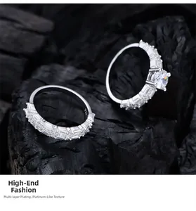 Detailed macro of S925 silver rings set with premium stones on dark textured wood