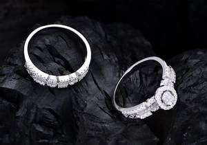 Macro shot of S925 silver rings with oval zircon on a textured black stone background