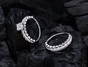 Macro detail of S925 sterling silver ring set showing 925 stamp and scalloped lace texture