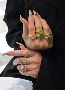 Close-up of multicolor rectangular carbon diamond rings in S925 silver with gold plating