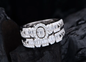 Macro detail of silver ring set with oval halo center and pave diamond-cut accents