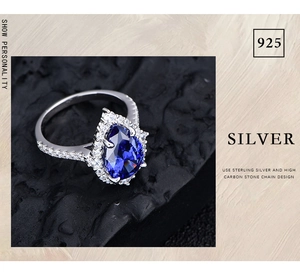 Macro shot of S925 sterling silver ring with pear-cut blue stone and high carbon diamonds