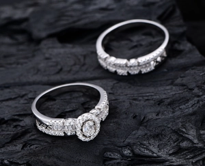 Macro shot of silver halo ring set with oval cubic zirconia on black rock background