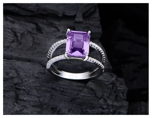 Macro shot of 925 silver ring featuring rectangle cut purple gem on charcoal background