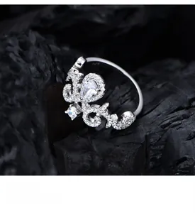 Macro shot of S925 silver tiara ring with pear-cut stone on black charcoal background