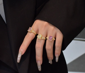 Three radiant cut cocktail rings with pink and yellow stones in pavé gold settings