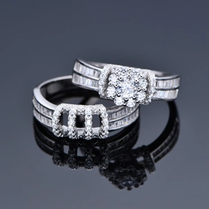 Elegant S925 silver halo bridal ring set with baguette-cut diamonds on mirror background
