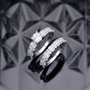 Luxury 925 sterling silver two-piece wedding ring set with round cut center stone and pavé