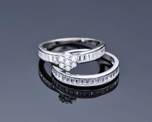 Macro view of two S925 silver stacked rings with baguette zircons and cluster setting