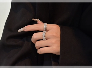 Close-up of stacked S925 silver snowflake rings with zircon crystals on a hand