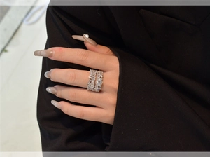 Detail shot of a layered S925 silver ring set with baguette and round cut diamonds