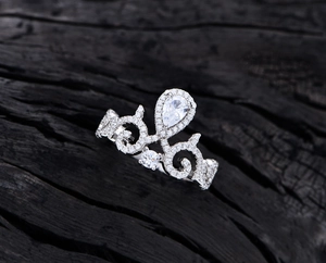 Macro shot of a vintage crown ring with water drop gemstone and pave diamond detailing