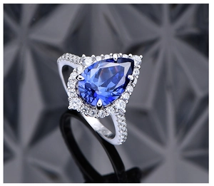 Macro detail of pear-cut tanzanite blue stone ring with pave diamonds in S925 silver