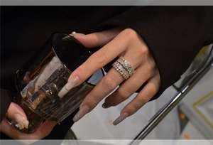 Close-up of wide multi-layer silver ring with baguette and round cut pavé crystals