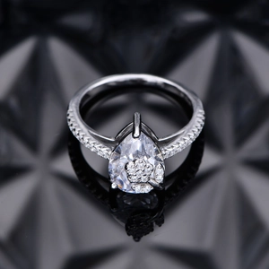Elegant pear-cut diamond ring with floral cluster setting on polished white gold band