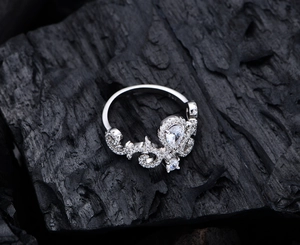 Macro detail of S925 sterling silver crown ring with pear-cut zircon on charcoal background