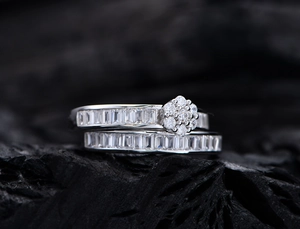 Detail of silver S925 ring set with marquise and baguette cubic zirconia on charcoal